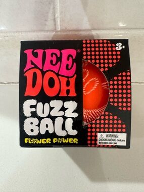 NIB NEEDOH Flower Power fuzz ball - Orange SPECIAL smiley face design